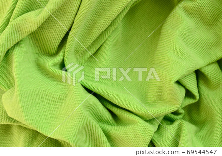 The texture of the fabric is bright green. Material for making s 69544547