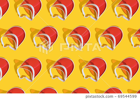 Bright red sports sun cap on a yellow background with a hard shadow. Creative texture food banner. Top view. Flat lay. Bright red sports sun cap on a yellow background with a hard shadow. Creative texture food banner. Top view. Flat lay. 69544599