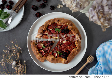 Figs galette with fresh figs. Traditional rustic fruit homemade pie, top view. 69545156
