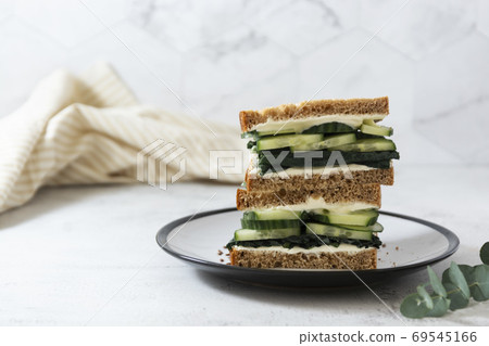 Healthy sandwich with cucumber and kale leaves. Vegan food snack, breakfast. Copy space. 69545166
