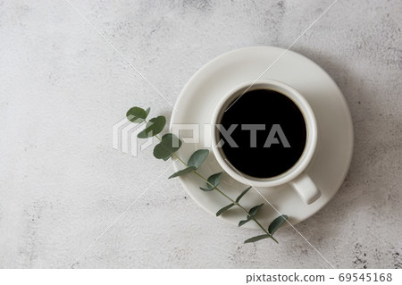 Cup of coffee, eucalyptus branch. Flat lay, top view, copy space Cup of coffee, eucalyptus branch. Flat lay, top view, copy space 69545168
