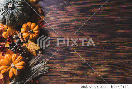 Autumn background decoration from dry leaves and pumpkin on dark Autumn background decoration from dry leaves and pumpkin on dark 69547515