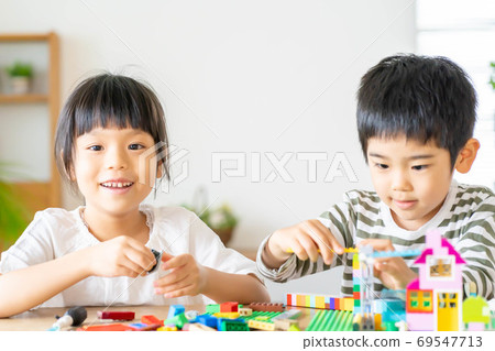 Brothers of girls and boys playing with blocks 69547713