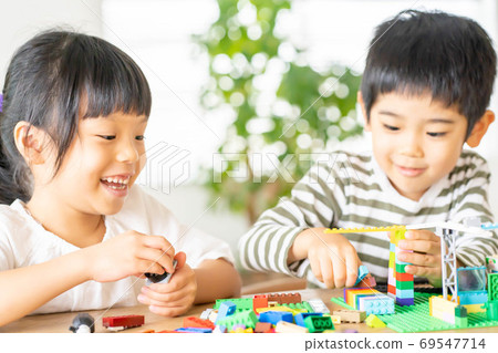 Brothers of girls and boys playing with blocks 69547714