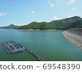 Floating solar panel on the lake with arch dam, mountain background. This technology called FPV or Floating photovoltaic. Clean technology concept and output is renewable energy. 69548390