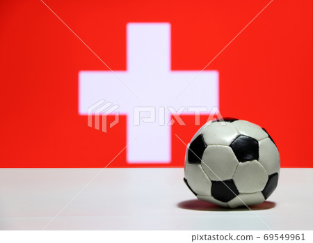 Small football on the white floor with out focus white cross on Small football on the white floor with out focus white cross on 69549961