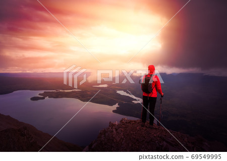Girl Hiking on top of a Mountain Peak Girl Hiking on top of a Mountain Peak 69549995