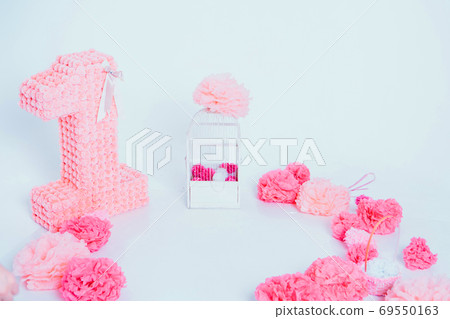 the concept of a festive interior, attributes of a holiday, decorative elements: flowers, cake on a white background. Copy space the concept of a festive interior, attributes of a holiday, decorative elements: flowers, cake on a white background. Copy space 69550163