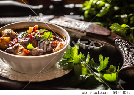 Deer stew in a bowl hunting weapon as a decoration 69553032