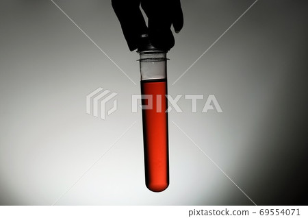 Red gel-like liquid in a transparent container Red gel-like liquid in a transparent container 69554071