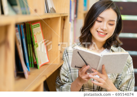 Woman in library Woman in library 69554074