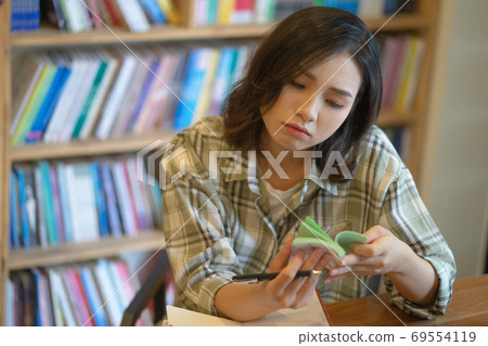 Woman in library Woman in library 69554119