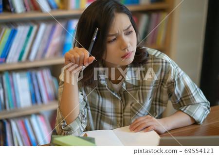 Woman in library Woman in library 69554121