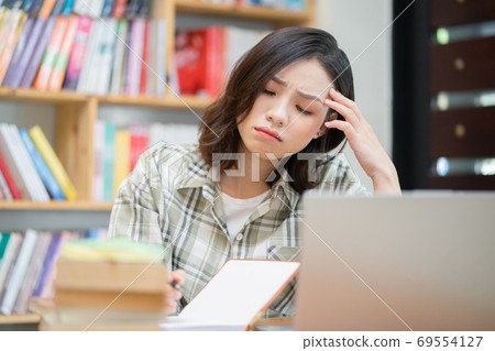 Woman in library Woman in library 69554127