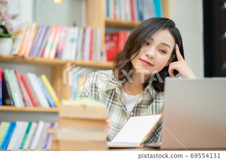 Woman in library Woman in library 69554131