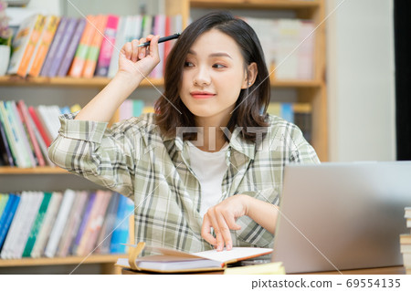 Woman in library Woman in library 69554135