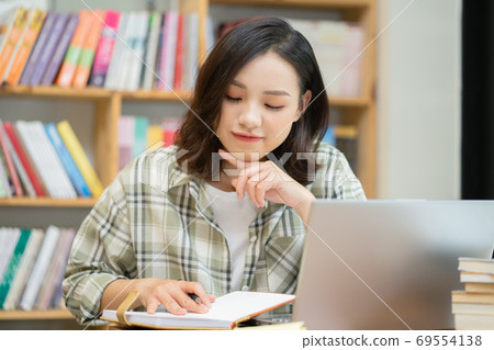Woman in library Woman in library 69554138
