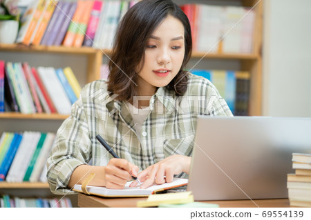 Woman in library Woman in library 69554139