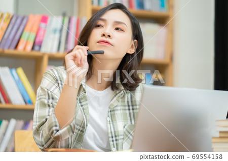 Woman in library Woman in library 69554158