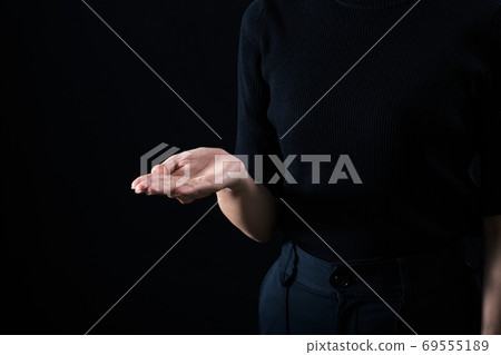 A woman holding a palm of the hand A woman holding a palm of the hand 69555189