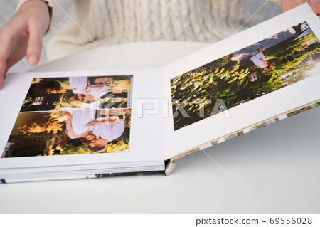 close up. woman flips through photo book  69556028