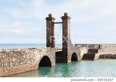 Bridge of the Balls. Puente de las Bolas leads to San Gabriel Castle in the port city of Arrecife on the Spanish island of Lanzarote. Bridge of the Balls. Puente de las Bolas leads to San Gabriel Castle in the port city of Arrecife on the Spanish island of Lanzarote. 69556267