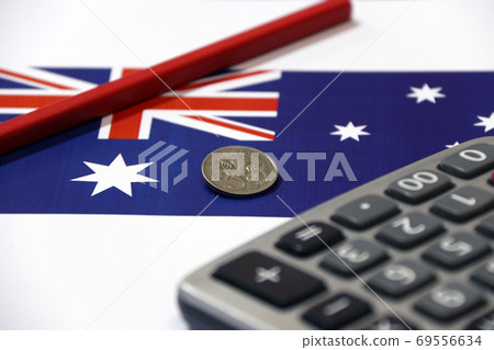 Five cents coin of Australia on Australian nation flag with red pencil and calculator Five cents coin of Australia on Australian nation flag with red pencil and calculator 69556634