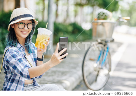 Happy woman taking selfie 69556666