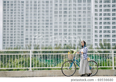 Happy woman with bicycle Happy woman with bicycle 69556680