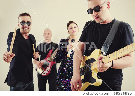 Band member playing guitar 69556980