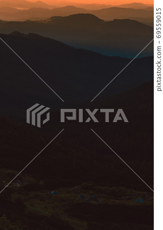 Fog or haze at sunrise in the Carpathians, Ukrainian Pip Ivan and sunrise near Montenegro, picturesque mountain landscapes. Fog or haze at sunrise in the Carpathians, Ukrainian Pip Ivan and sunrise near Montenegro, picturesque mountain landscapes. 69559015