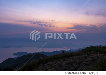 Asahi rising to the Tara mountain range overlooking Omura city from Kotonoodake, Omura city, Nagasaki prefecture 69559113