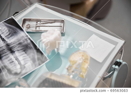 Dentists table with tools and props on it 69563083