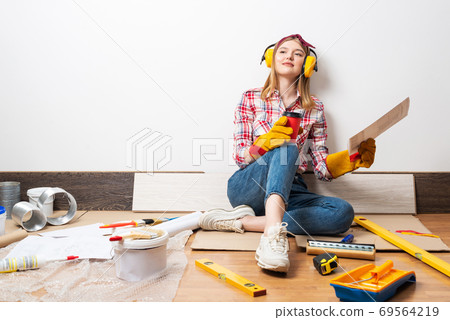 Dreamy girl in protective headphones and gloves 69564219