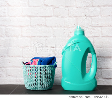 plastic round laundry basket and green bottle with liquid laundry powder plastic round laundry basket and green bottle with liquid laundry powder 69564619