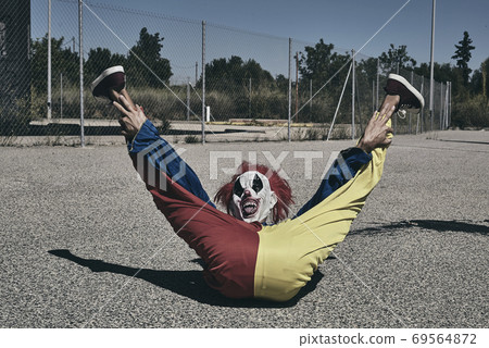 clown lying on the floor with his legs raised clown lying on the floor with his legs raised 69564872