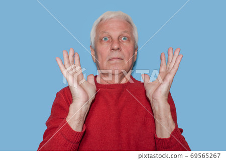 Excited senior man with arms raised Excited senior man with arms raised 69565267
