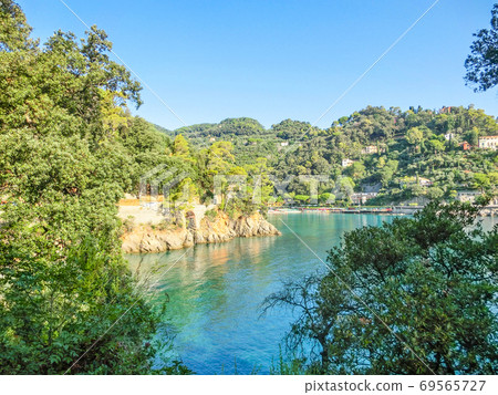 The beach near portofino in genoa on a blue sky and sea background The beach near portofino in genoa on a blue sky and sea background 69565727