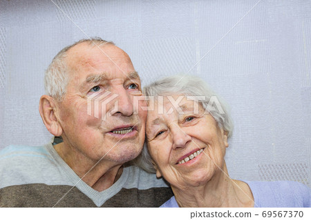 Happy affectionate mature old man and woman embracing Happy affectionate mature old man and woman embracing 69567370