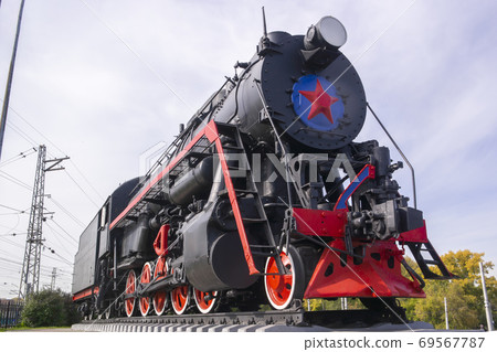 old locomotive stands on a pedestal as a monument old locomotive stands on a pedestal as a monument 69567787