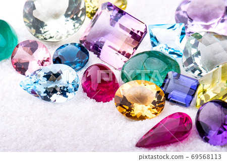 Group of gemstones on white sand. 69568113