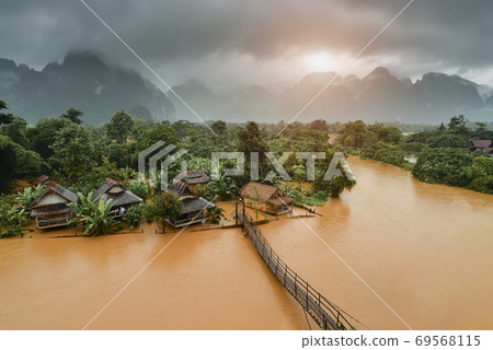 Wooden bridge across the floating river. Wooden bridge across the floating river. 69568115