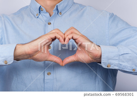 Male hands show Heart sign by fingers. Love concept 69568301