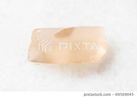 rough Topaz crystal on white marble rough Topaz crystal on white marble 69569045