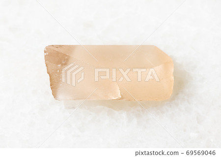 unpolished Topaz crystal on white marble unpolished Topaz crystal on white marble 69569046