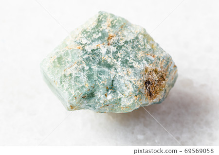 rough Apatite rock on white marble 69569058