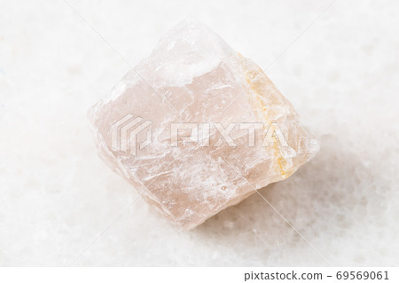 rough pink Fluorite rock on white marble 69569061