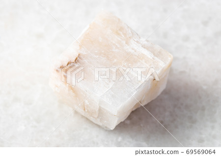 unpolished Calcite rock on white marble 69569064