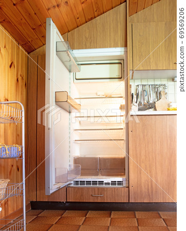 Old fridge in a dated kitchen Old fridge in a dated kitchen 69569206
