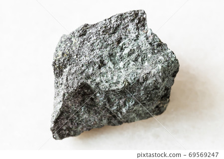 unpolished Magnetite ore on white marble unpolished Magnetite ore on white marble 69569247